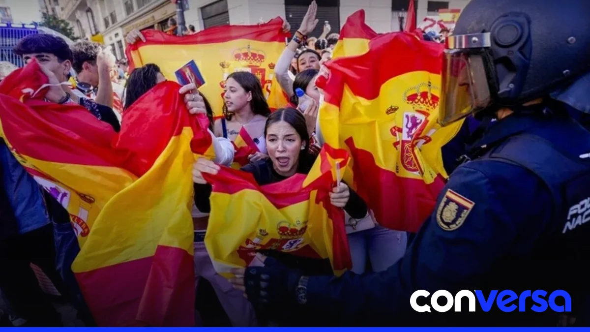 Manifestantes con banderas de España rodean a los acampados en la Puerta del Sol de Madrid.